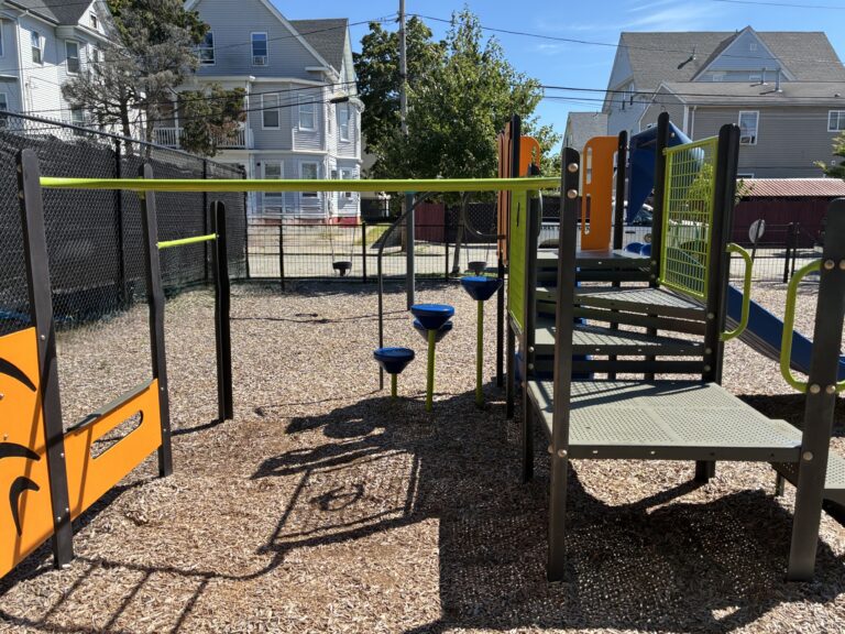 Mattie Smith Park play structure for ages 2-5 features a pod climber, steering wheel panel, and slide
