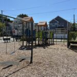 Mattie Smith Park features separate play structures for ages 2-5 and 5-12 along with park benches and 4 belt swings