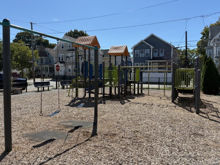 Mattie Smith Park features separate play structures for ages 2-5 and 5-12 along with park benches and 4 belt swings