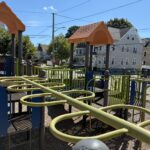 Mattie Smith Park play structure for ages 5-12 features two overhead ladders and various climbers