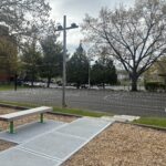 Miguel Luna Park renovated basketball court with paved walkway and staircase from the playground