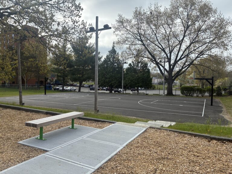 Miguel Luna Park renovated basketball court with paved walkway and staircase from the playground