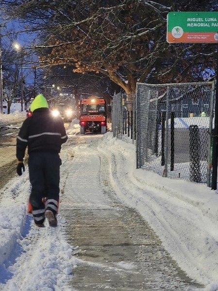 Miguel Luna Park parks crew removing snow from sidewalk on Sackett St Winter 2025-26
