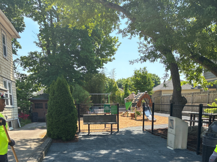 Morris Ave Park entrance features bench seating and little free library