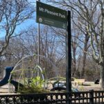 Mt Pleasant Little League Park view of the playground from the avenue in early Spring with significant trees