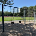 Mt Pleasant Little League Park playground swings for ages 2-12 behind the left field wall of field 2