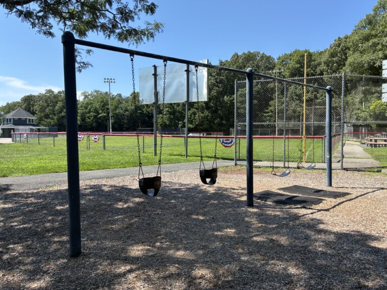 Mt Pleasant Little League Park playground swings for ages 2-12 behind the left field wall of field 2