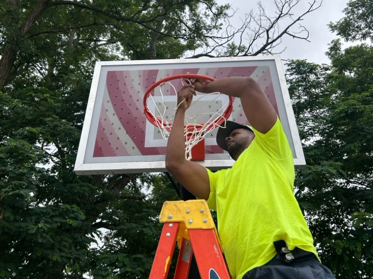 Ninth St Park maintenance replacing the basketball net