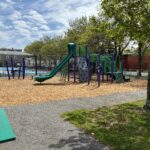 Pastore Park playground for ages 5-12 viewed from a picnic table in May 2026