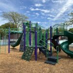 Pastore Park play structure for ages 5-12 features a spiral slide and multiple different climbers