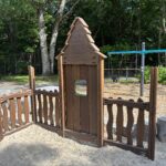 Paterson Park play houses and facades in a sand play area for ages 2-5