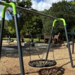 Paterson Park bird's nest swing with activity on the playground