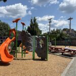Peace & Plenty Park play equipment for ages 5-12 includes two slides and rock climbing wall