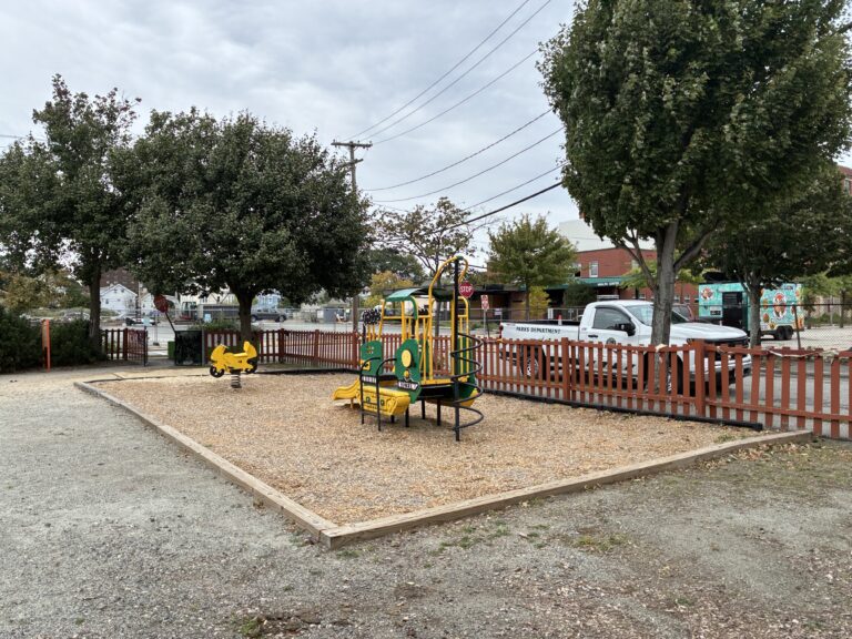 Peace & Plenty Park play area for ages 2-5 includes a bulldozer themed climber with slide and motorcycle spring rocker