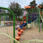 Peace & Plenty Park play structure for ages 5-12 and picnic area, looking at the pod steps leading to the transfer stairs