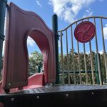 Pleasant St Park playground slide entrance and steering wheel for ages 2-12