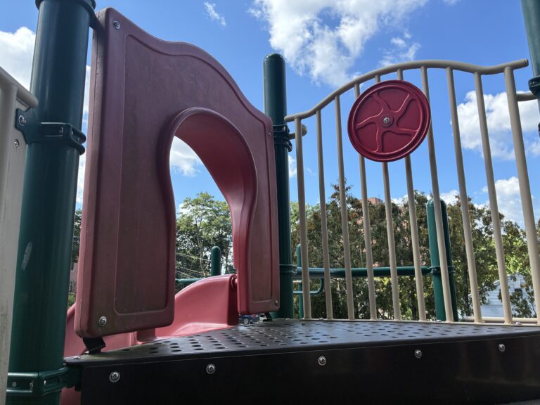 Pleasant St Park playground slide entrance and steering wheel for ages 2-12