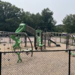 Prete-Metcalf Park playground for ages 5-12 features a variety of climbing options in addition to a traditional post and deck structure with two different slides