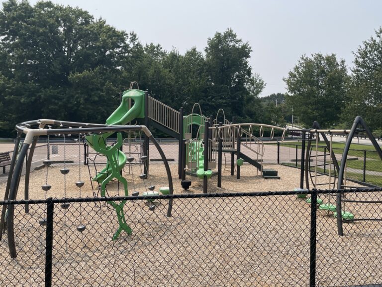 Prete-Metcalf Park playground for ages 5-12 features a variety of climbing options in addition to a traditional post and deck structure with two different slides