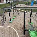 Prete-Metcalf Park playground for ages 5-12 view of overhead loop ladder and other climbing features from the main structure