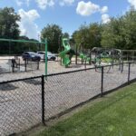 Prete-Metcalf Park playground for ages 5-12 is fenced in and adjacent to parking and parkour fitness areas