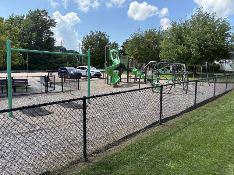 Prete-Metcalf Park playground for ages 5-12 is fenced in and adjacent to parking and parkour fitness areas