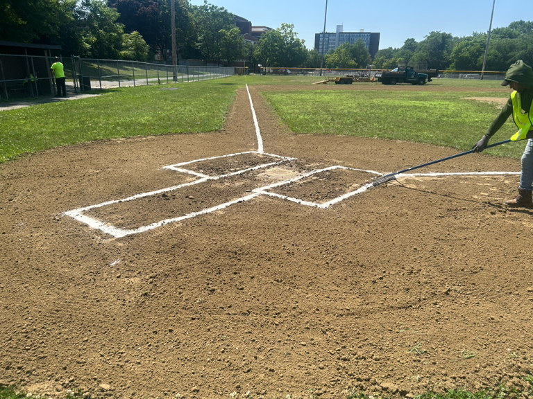 Prete-Metcalf Park Field 2 being groomed by Parks ballfield crew, view up the 3rd base line from home plate