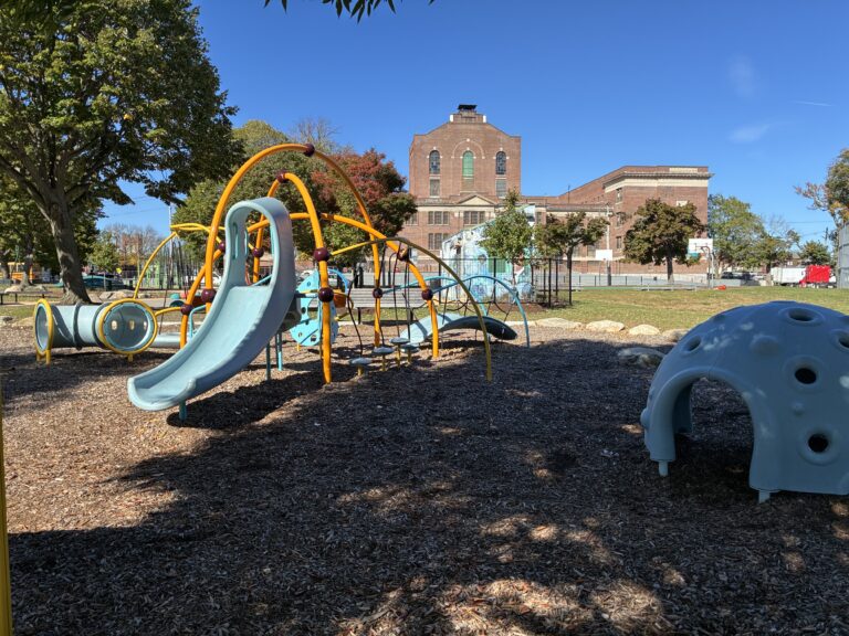 Richardson Park play area for ages 2-5 with ample shade and iconic Providence architecture in the background- Roger Williams Middle School