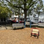 Ridge St Park playground seating area with shade tree