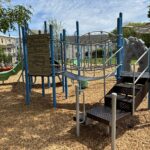 Ridge St Park playground for ages 2-12 features a belt bridge and sunken treasure hunt