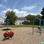Ridge St Park features a red car spring rocker for ages 2-5