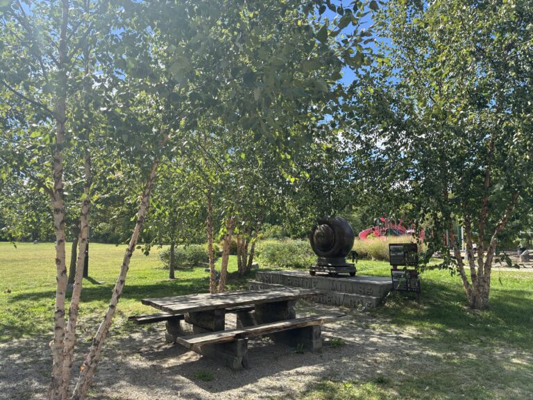 Riverside Park picnic area between the parking lot and playground with interpretive history and artifacts