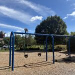 Riverside Park swings for ages 2-12 and classic climbing structures for ages 5-12