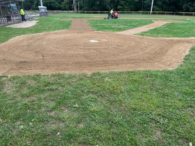 Roger Williams Park Tim O'Neil Field 2 infield being groomed looking up the third base line from behind home plate