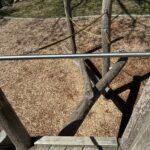 Roger Williams Park Bear Ground play sculpture looking down from the slide deck at the log climbing access