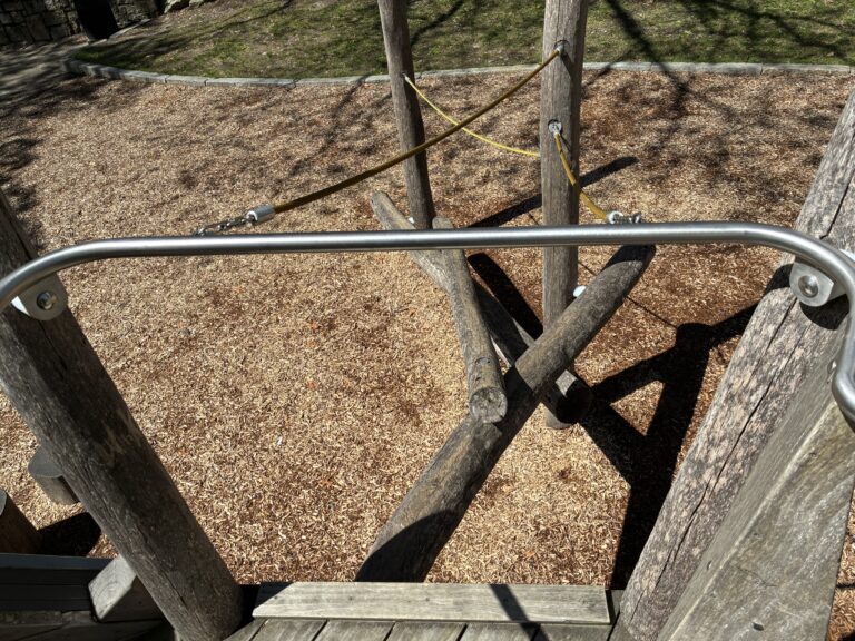 Roger Williams Park Bear Ground play sculpture looking down from the slide deck at the log climbing access
