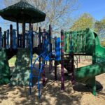 Sessions Street Park classic playground structure for ages 5-12 features two slides, a covered central tower, and various climbers