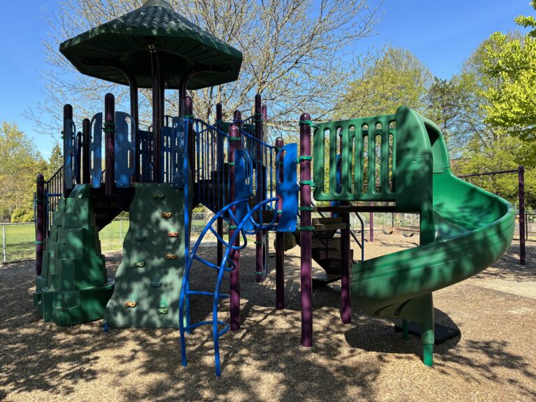 Sessions Street Park classic playground structure for ages 5-12 features two slides, a covered central tower, and various climbers