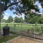 Sessions Street Park action on the T-Ball field viewed from inside the fenced playground