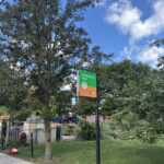 Sessions Street Park entrance sign in front of the garden