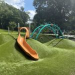 Viscolosi Park synthetic turf berm with slide and play structures for ages 5-12