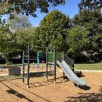 Viscolosi Park play structure for ages 2-5 includes a slide accessible via transfer stairs, cargo net, and accessible storefront activity panel