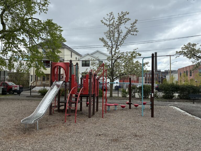 Warren St Park play structure for ages 5-12 features a classic metal slide
